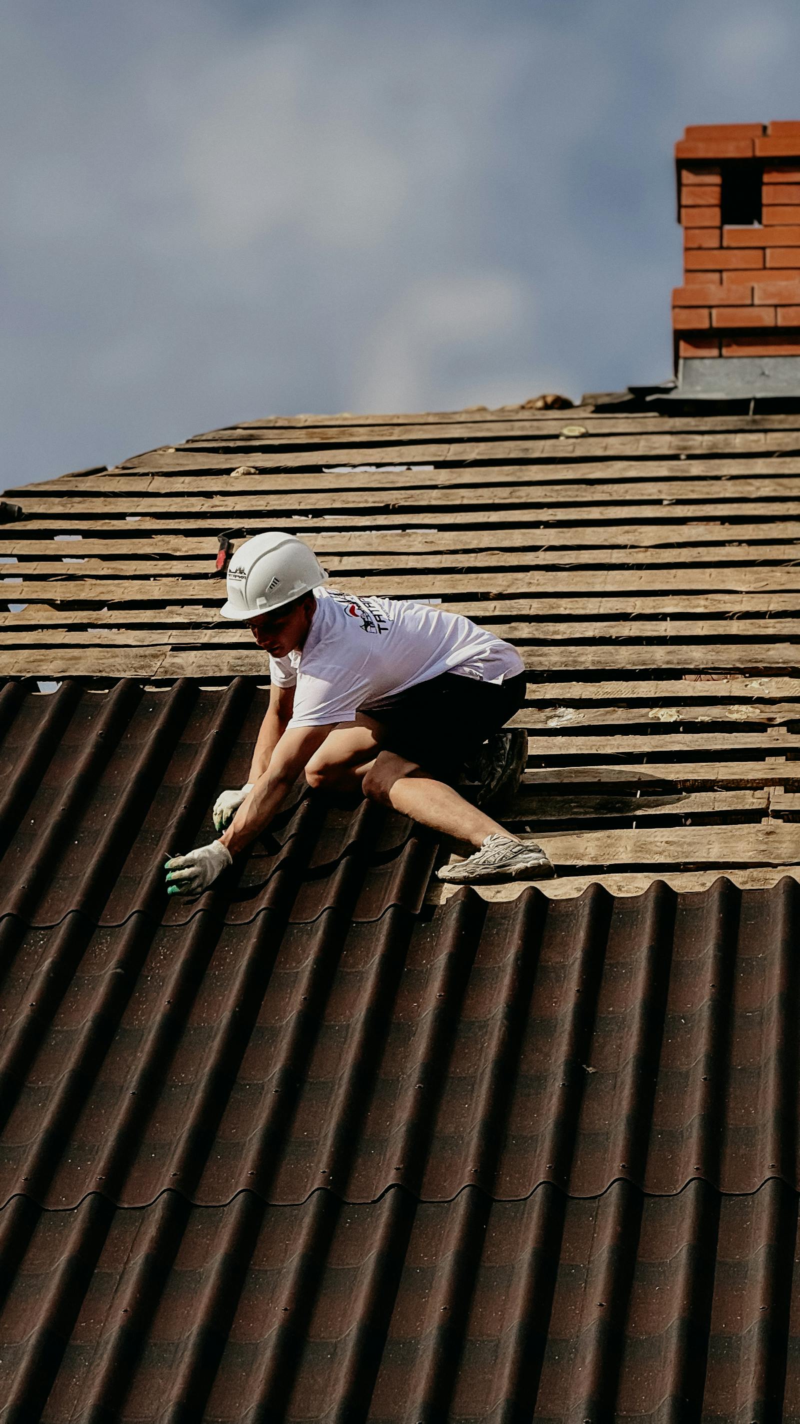 Roofsmic crew installing a new asphalt shingle roof on a Texas home